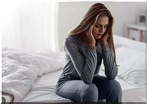 Woman thinking sitting on the bed