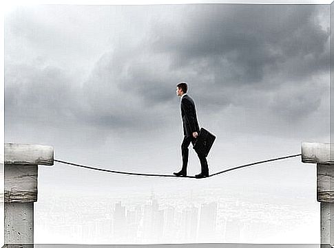 Man walks on a suspended rope to represent attitudes that do not express fear but do