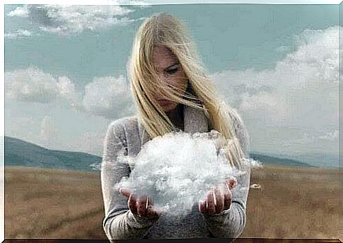 Woman holds clouds in her hands.