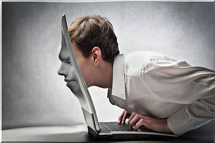 Man with his face absorbed by the laptop screen