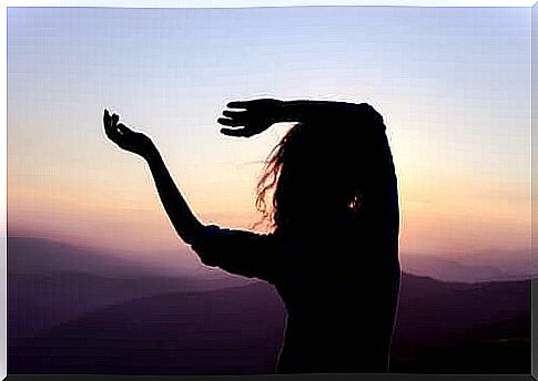 Woman dancing at dusk.