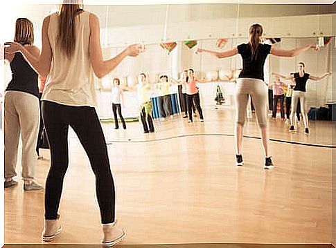 Women in the gym taking a dance class.