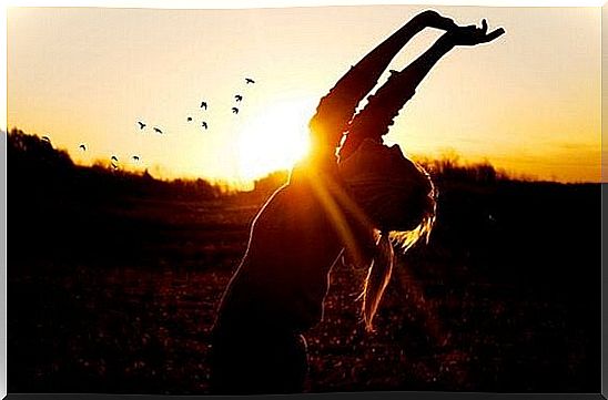 Girl stretches her arms up