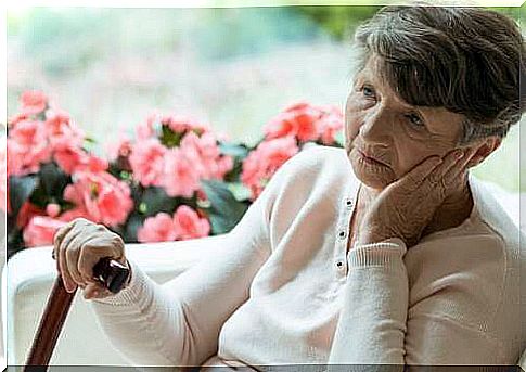 Elderly woman absorbed in her thoughts.