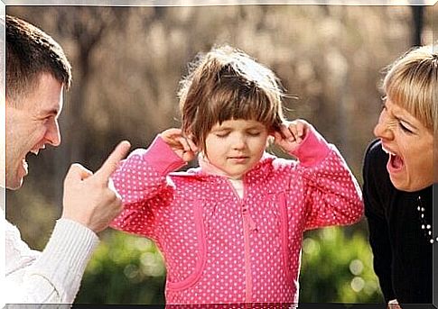 Little girl plugging her ears while she is in the middle of her parents yelling at her