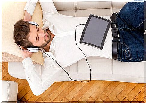 Boy listening to music on the sofa during pandemic time