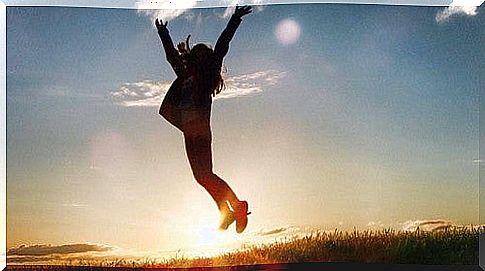 Girl jumping during sunrise.