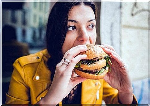 A woman eats a sandwich