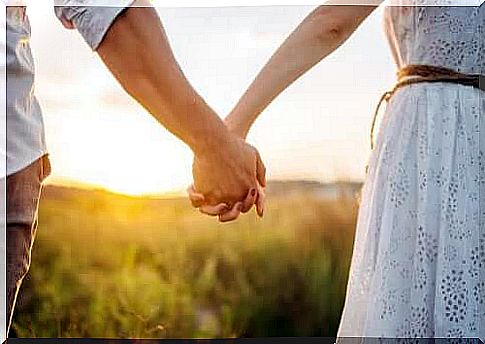 Couple walking in the countryside holding hands