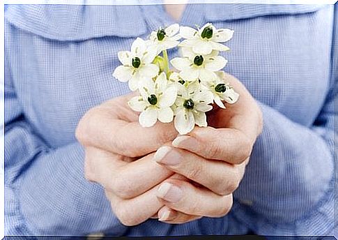 woman with flowers in her hand forgiveness