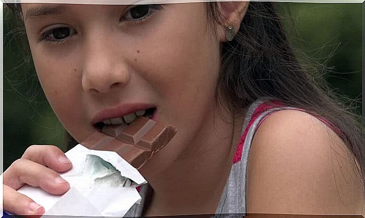 Little girl eating chocolate