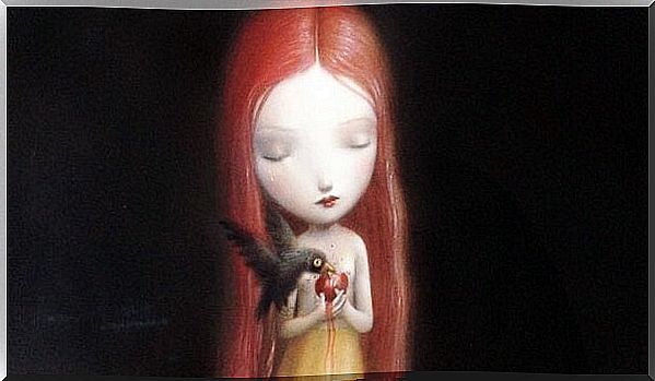 Sad little girl with blackbird eating her heart