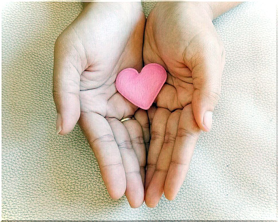 Hands with heart-shaped tablet