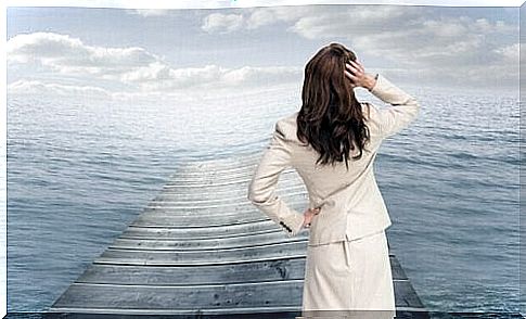 Woman in front of an ocean thinking about how to improve a bad day