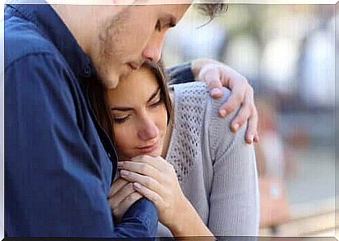 Boy hugging girl to offer emotional support