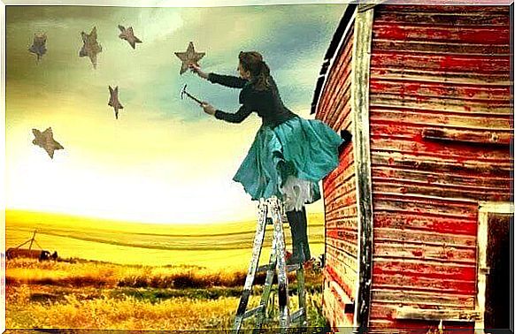 woman hangs stars in the countryside