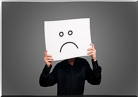 Pessimistic person with unhappy face placard