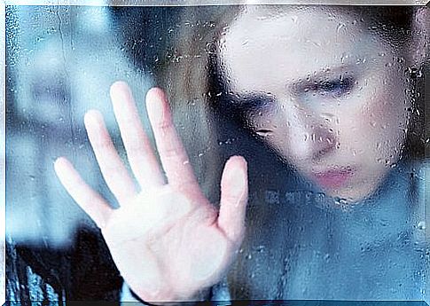 Girl with hand on the window