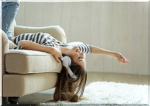 Girl listening to music on the sofa.