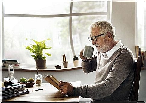 Elderly man with cup and book