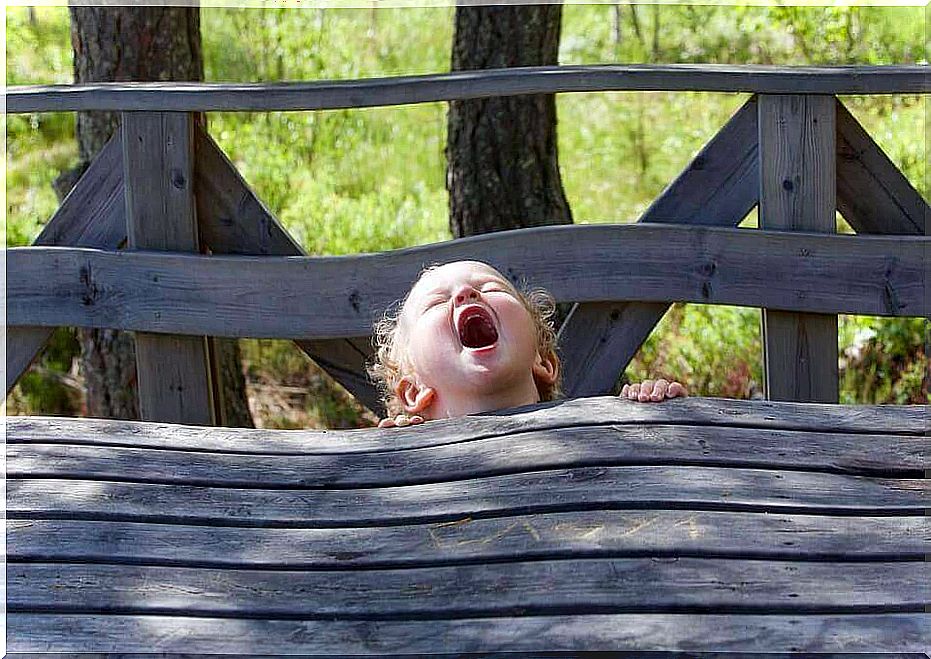 Child sitting on a bench