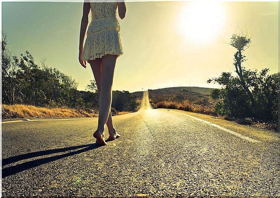 Woman walks barefoot on the street