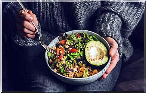 Woman with salad and avocado