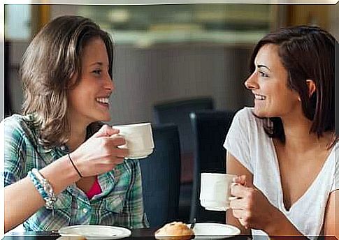 Friends talking while drinking coffee.